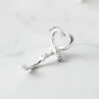クロスラインの入ったハートモチーフのハギーピアス（シルバー925）。金属アレルギー対応。