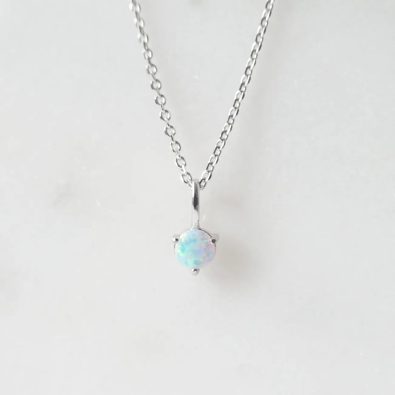 一粒オパールが虹色の遊色を放つシルバー925ロジウムプレーティングラウンドネックレス。シンプルで重ね着けにも最適／金属アレルギー対応。
